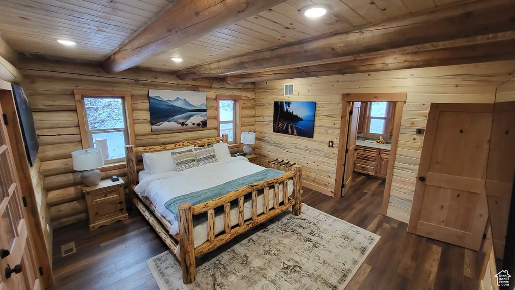 Bedroom featuring wooden ceiling, dark hardwood / wood-style floors, and rustic walls