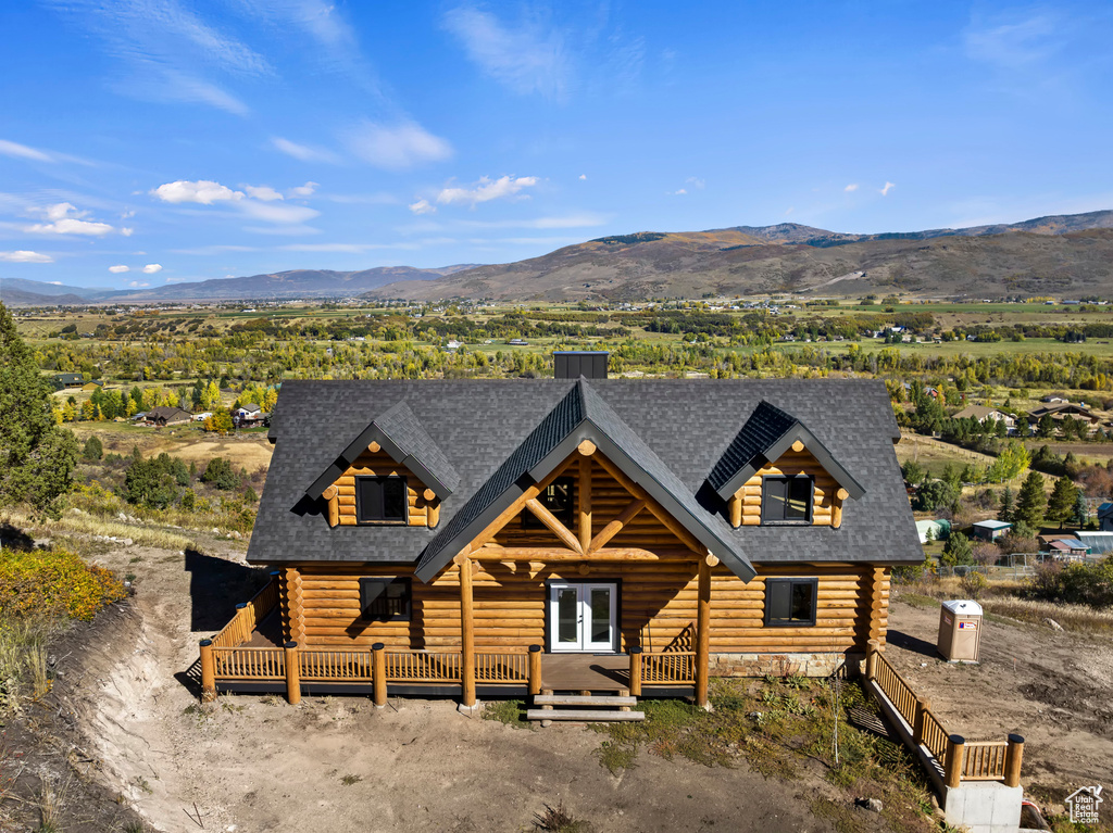 Log-style house with a mountain view and a porch