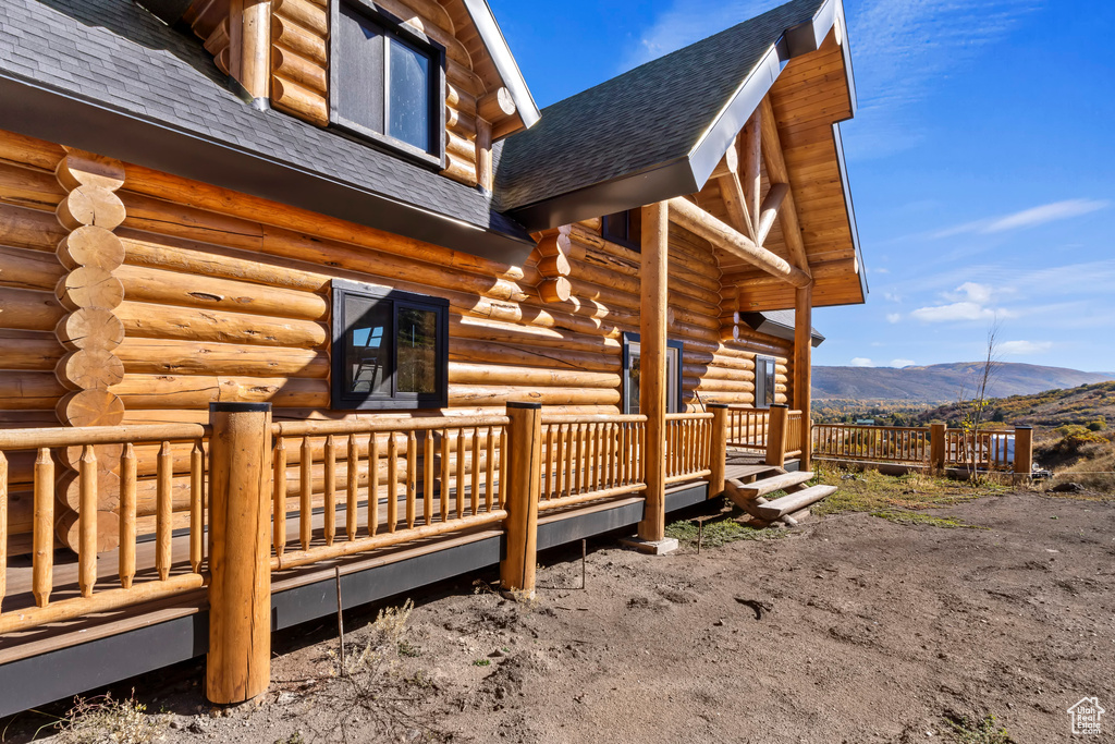 View of home's exterior with a deck with mountain view