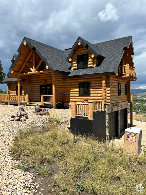 Log home featuring a garage