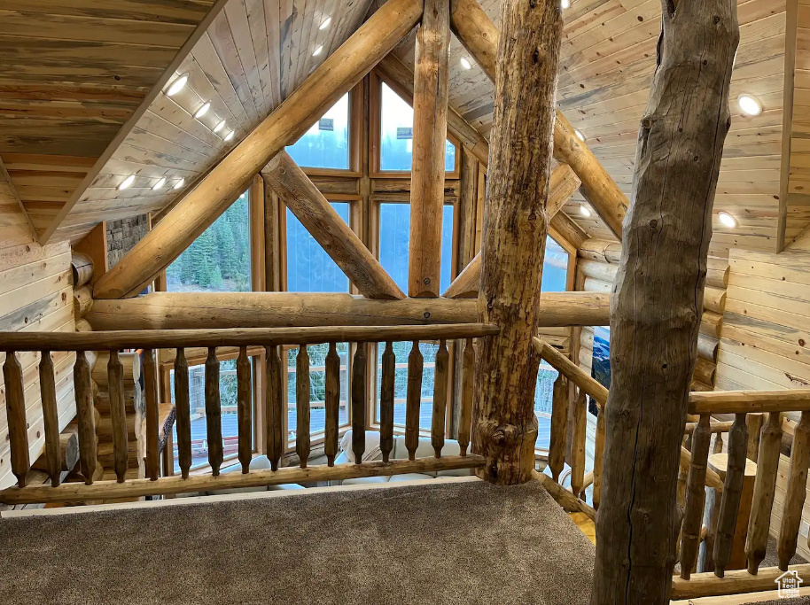 Interior space with wood walls, wood ceiling, and lofted ceiling