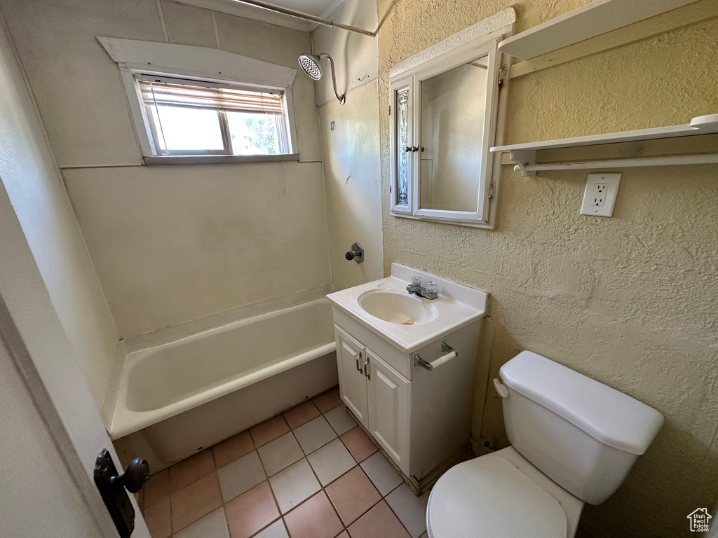 Full bathroom featuring toilet, washtub / shower combination, vanity, and tile patterned floors