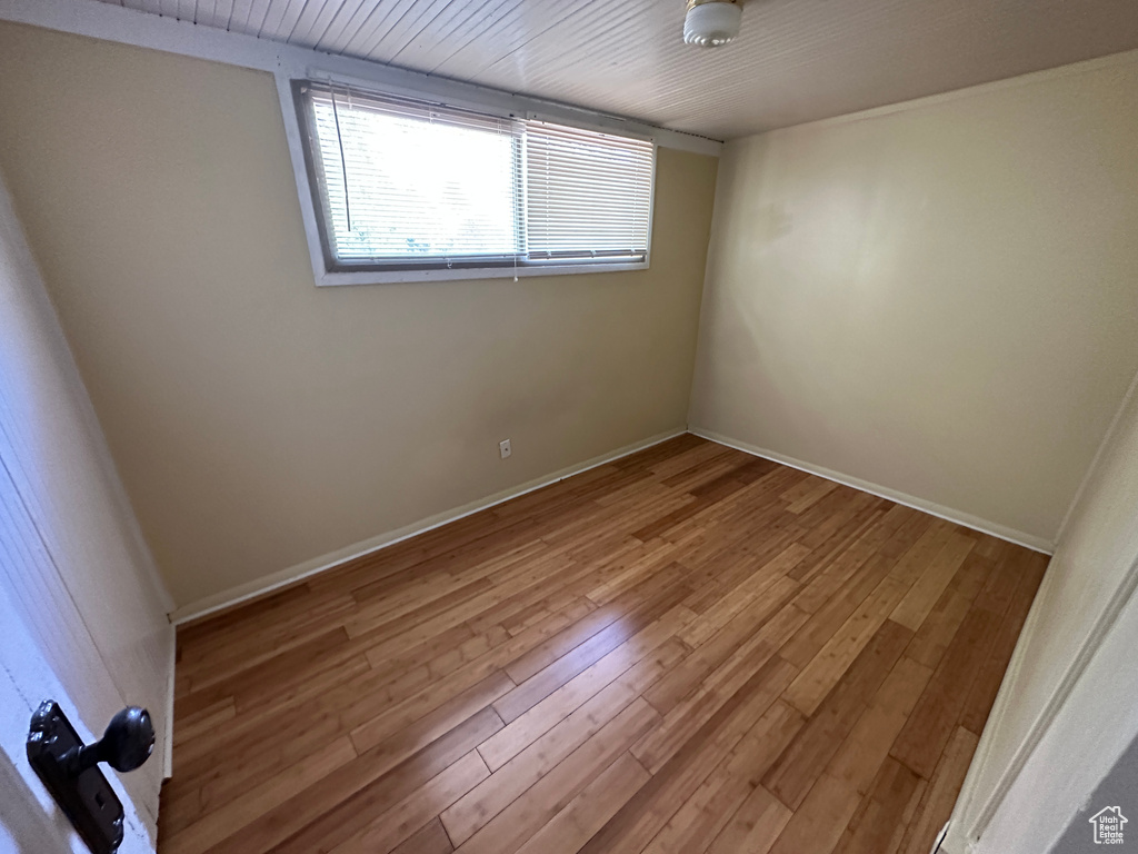 Unfurnished room with hardwood / wood-style floors