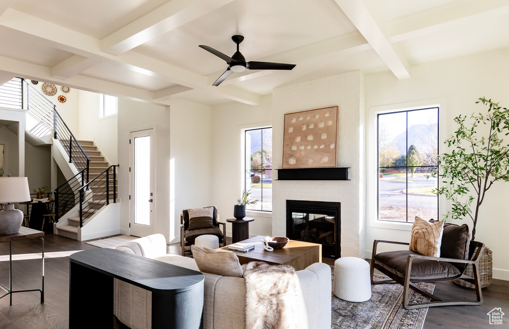 Living room with a fireplace, hardwood / wood-style flooring, and a healthy amount of sunlight