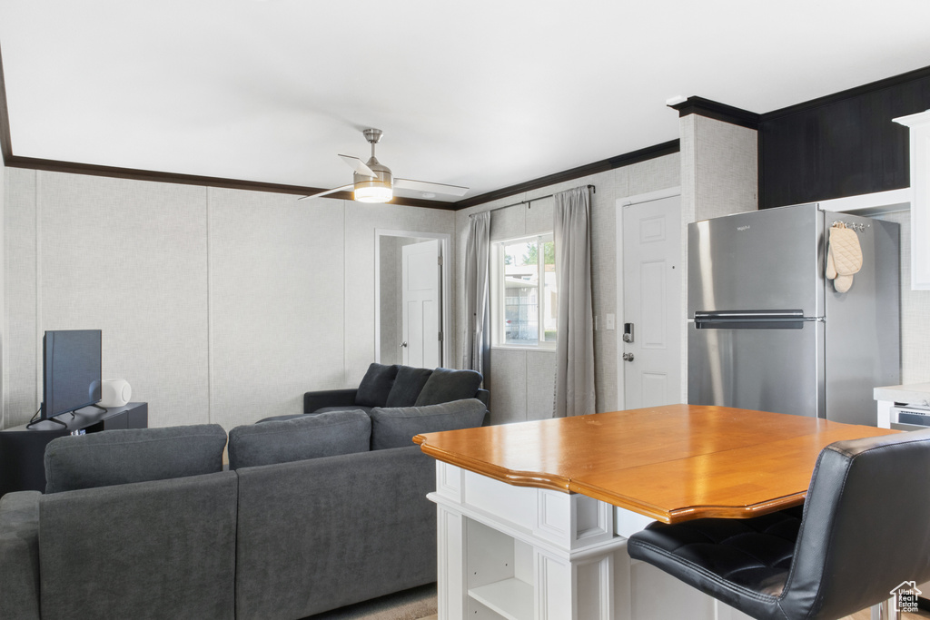 Interior space with ceiling fan and crown molding