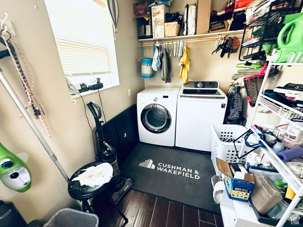 Laundry room with washing machine and dryer and wood-type flooring