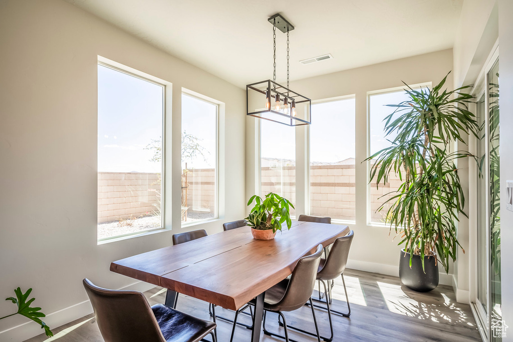 Dining room with a notable chandelier and light hardwood / wood-style floors