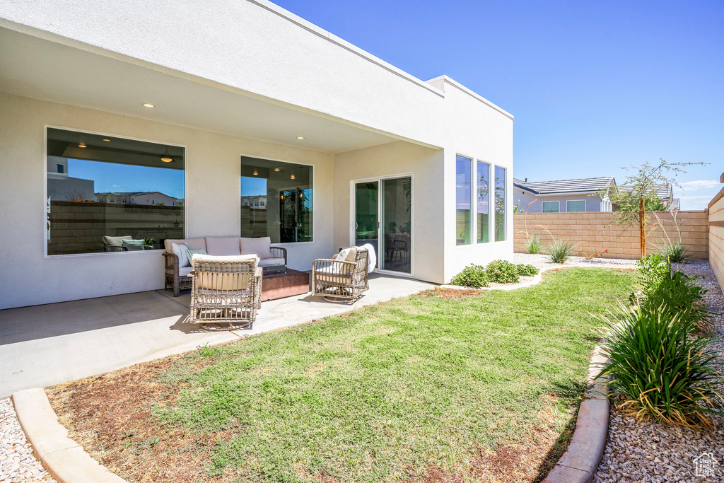 Exterior space featuring a patio area, outdoor lounge area, and a yard