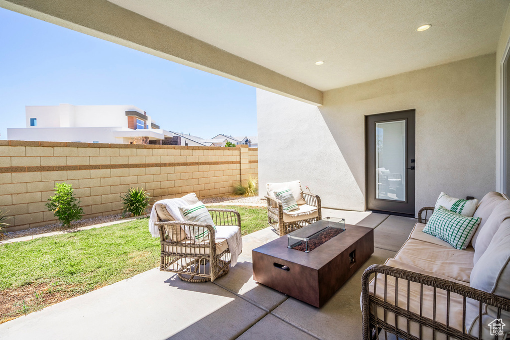 View of patio with an outdoor living space with a fire pit