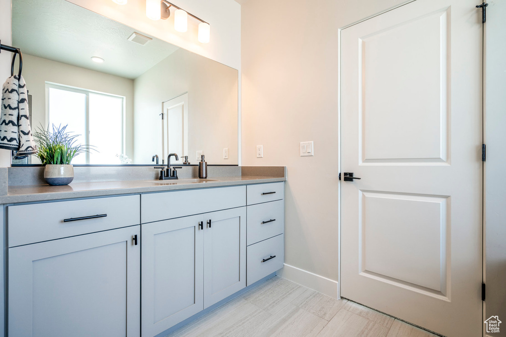 Bathroom featuring tile patterned flooring and vanity