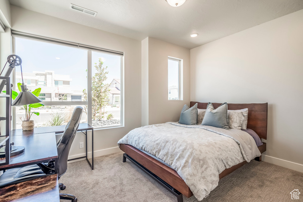 Bedroom featuring light carpet