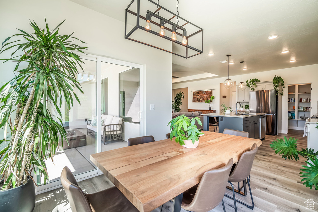 Dining room with sink and light hardwood / wood-style flooring