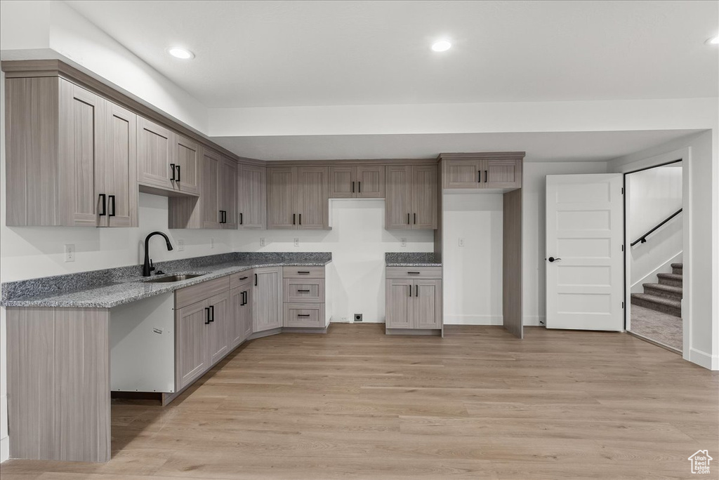 Kitchen with light wood-type flooring and sink