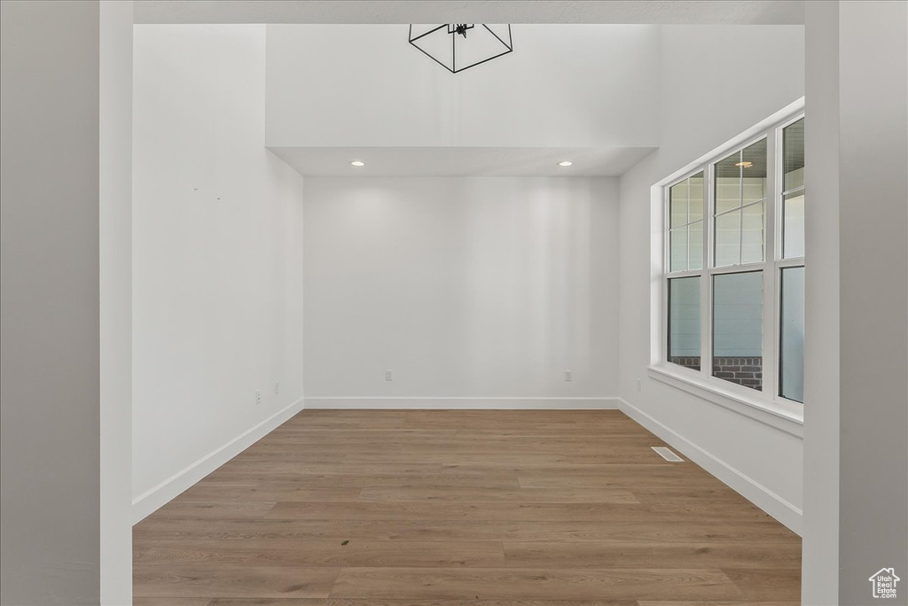 Empty room with hardwood / wood-style floors and a healthy amount of sunlight