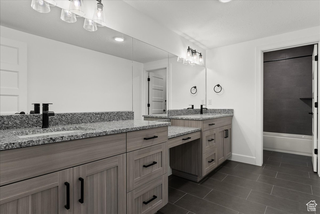 Bathroom with  shower combination, tile patterned flooring, and vanity