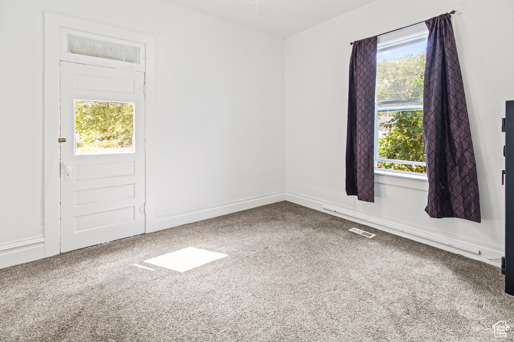 Carpeted empty room with a healthy amount of sunlight