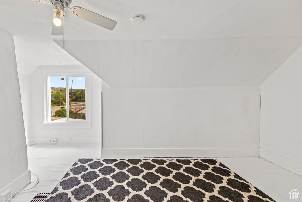 Additional living space featuring ceiling fan, light hardwood / wood-style flooring, and lofted ceiling