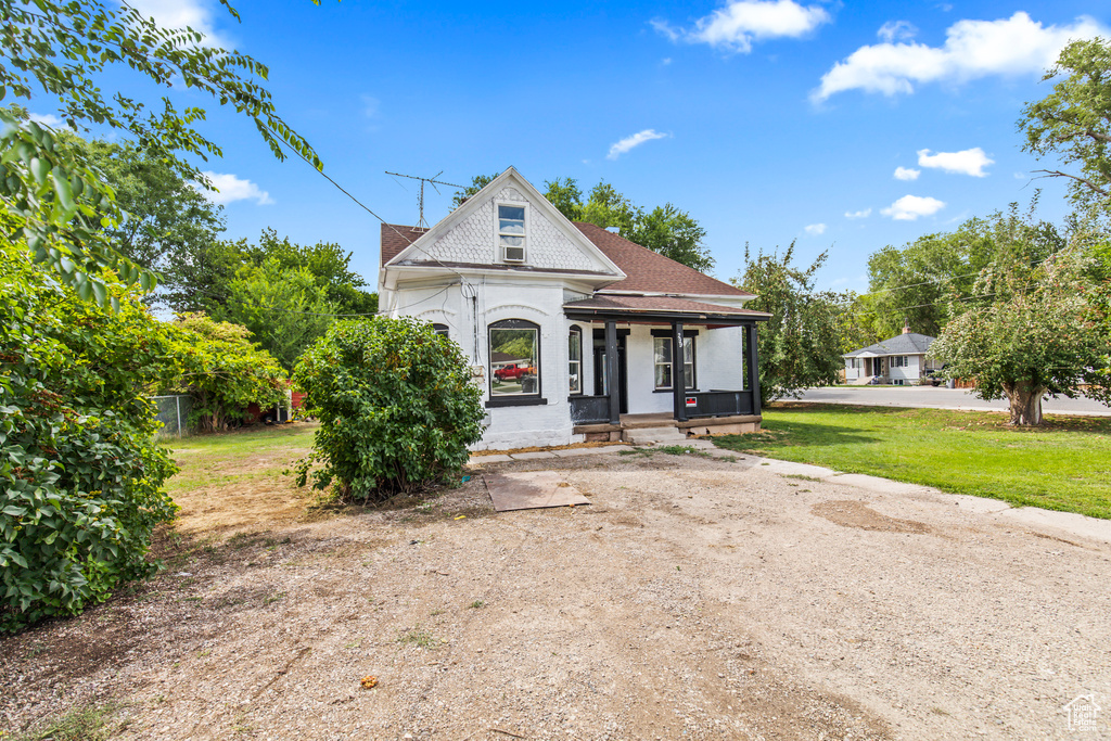 View of front of home with a front yard and a porch