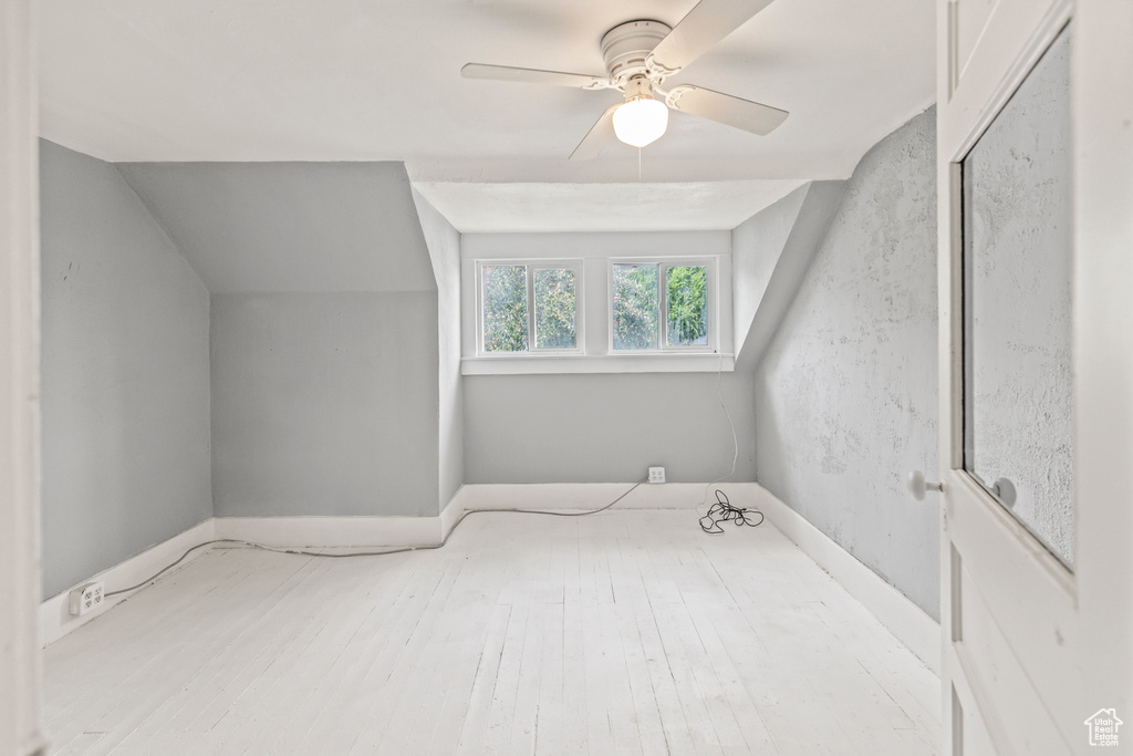 Bonus room with ceiling fan, vaulted ceiling, and light hardwood / wood-style flooring