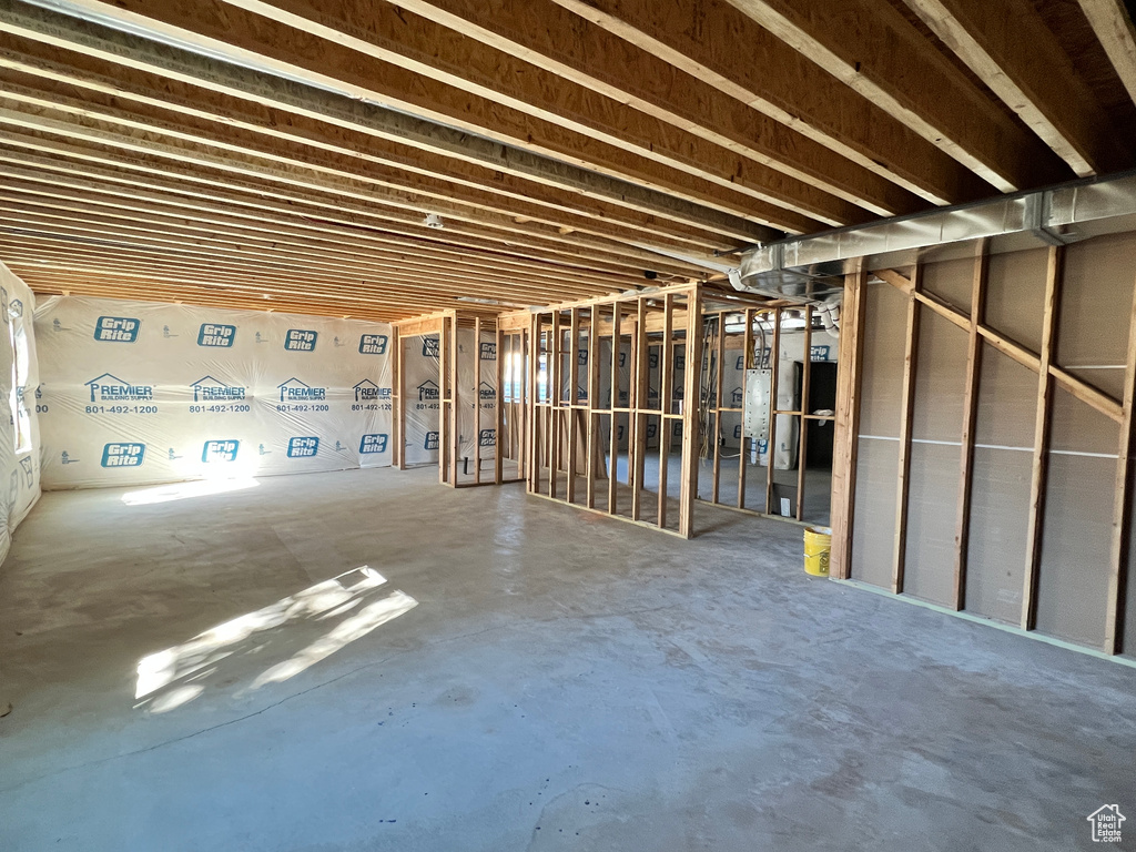 Misc room with gas water heater and concrete flooring