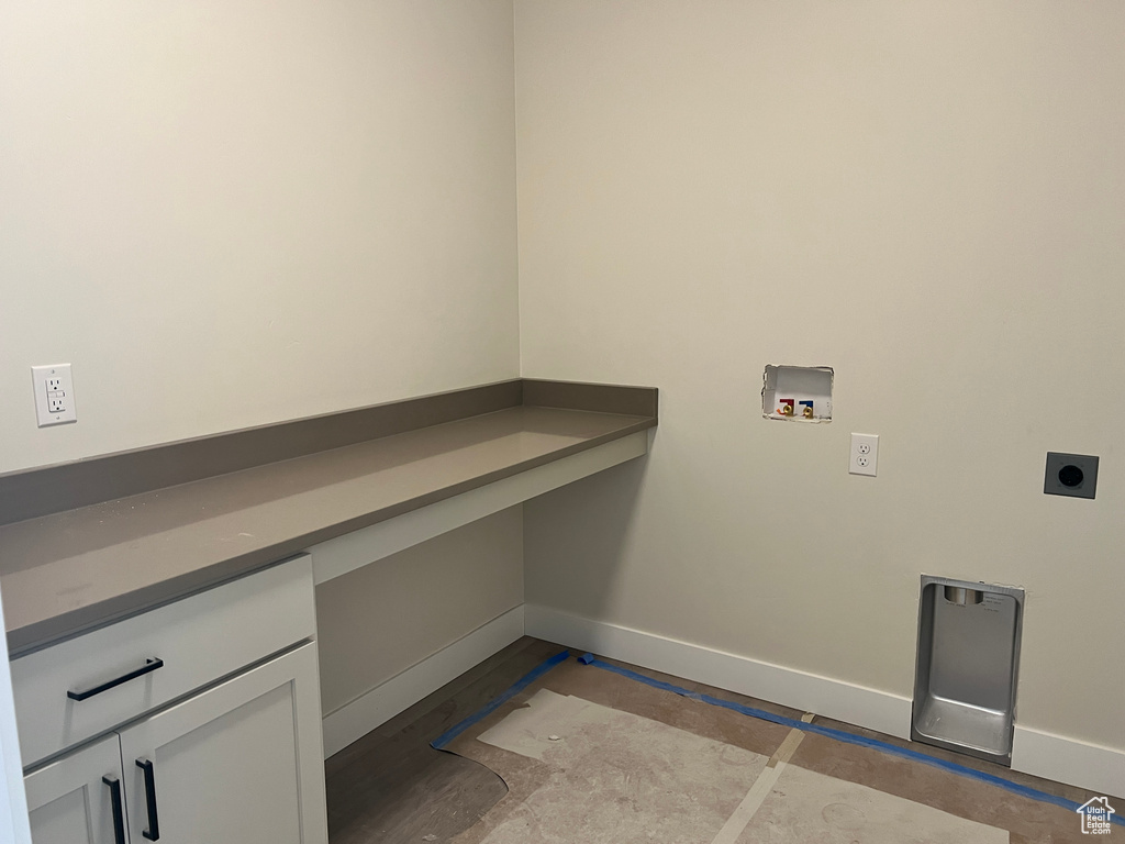 Laundry room featuring cabinets, hookup for a washing machine, and hookup for an electric dryer