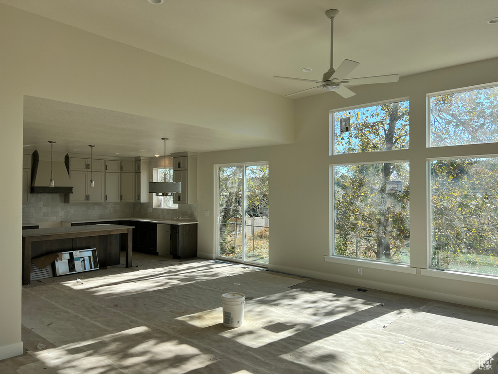 Unfurnished living room featuring ceiling fan