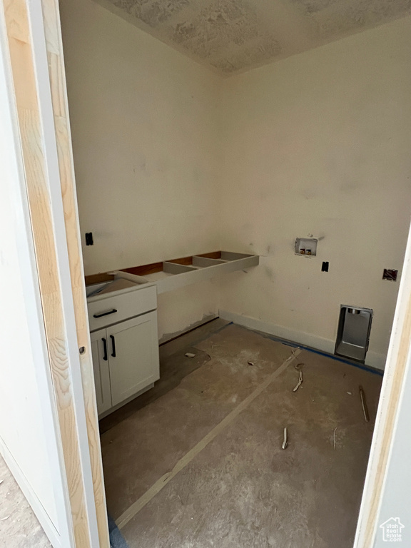 Laundry area featuring washer hookup and cabinets