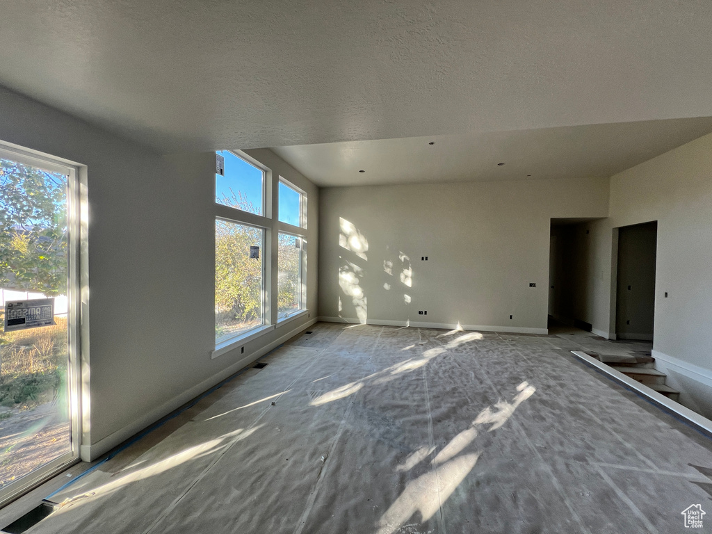 Unfurnished living room featuring a textured ceiling