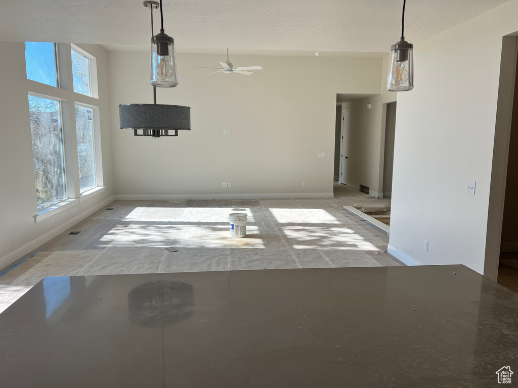 Unfurnished dining area with ceiling fan