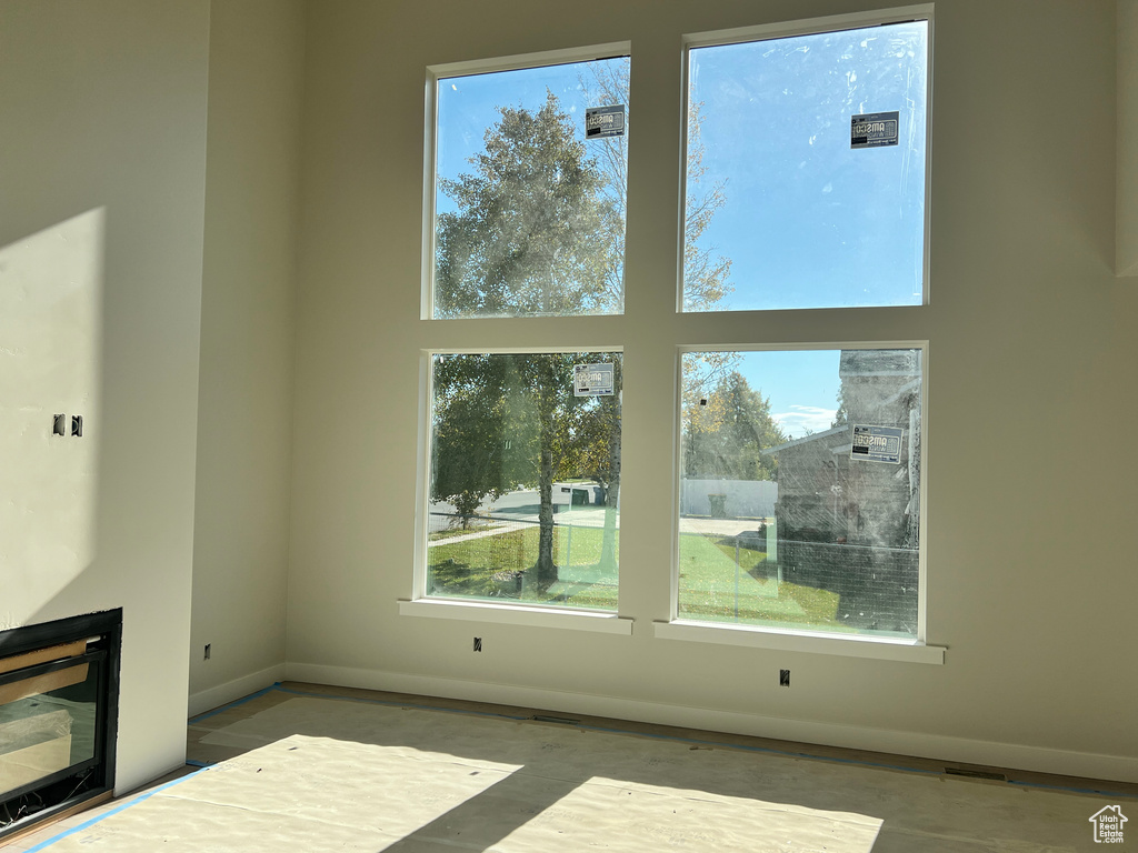 Unfurnished living room featuring a wealth of natural light