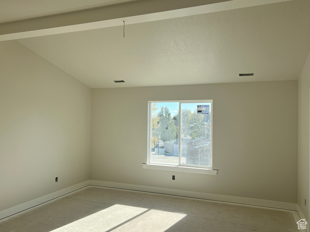 Spare room with lofted ceiling