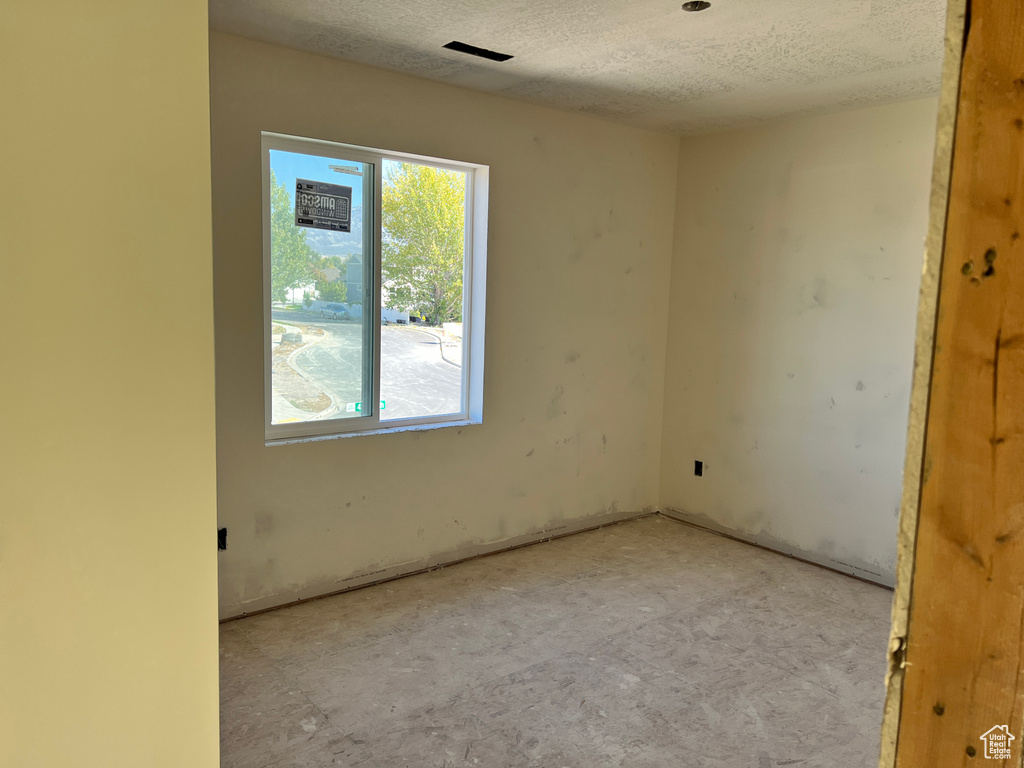 Spare room featuring a textured ceiling