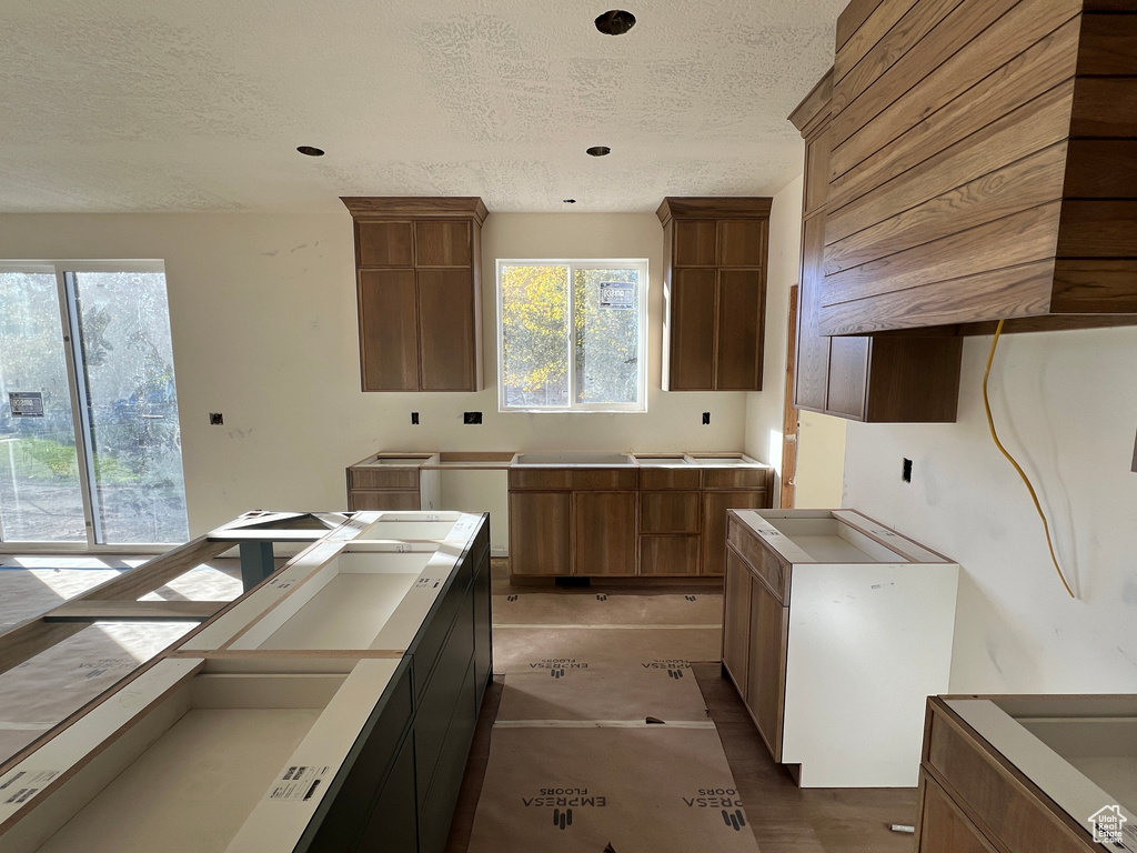 Kitchen featuring white fridge and a textured ceiling