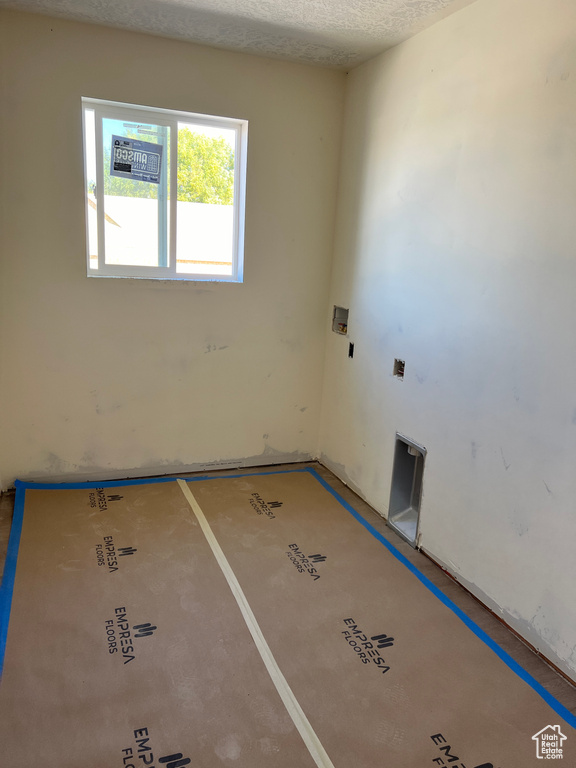 Unfurnished room with a textured ceiling