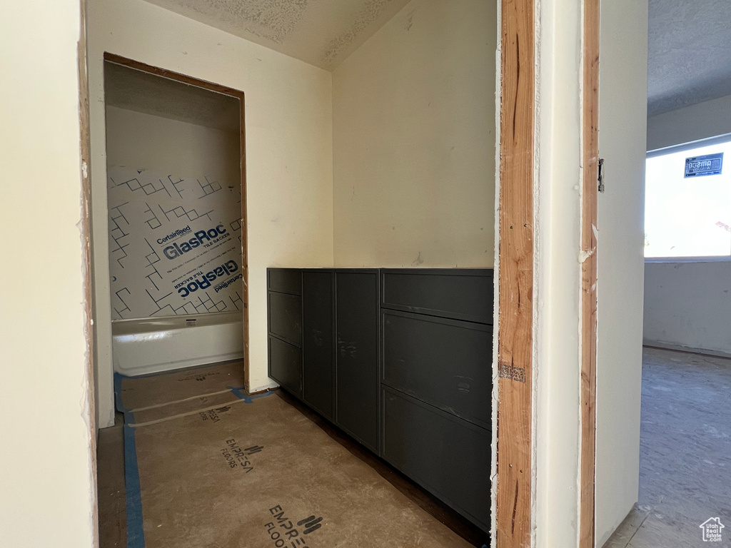 Hallway featuring a textured ceiling