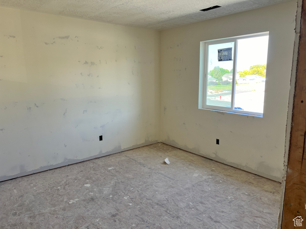 Empty room featuring a textured ceiling