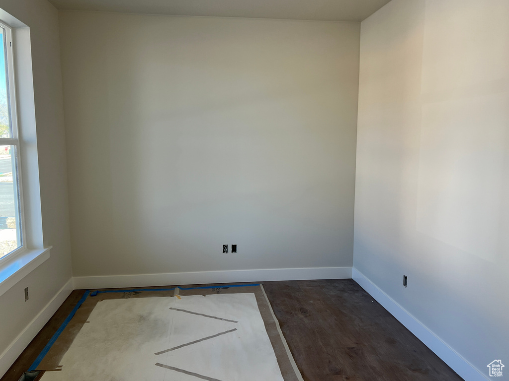 Unfurnished room with dark hardwood / wood-style floors