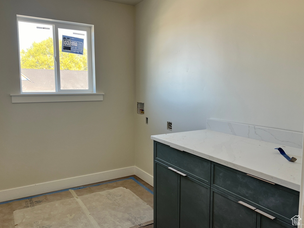 Clothes washing area featuring cabinets and washer hookup