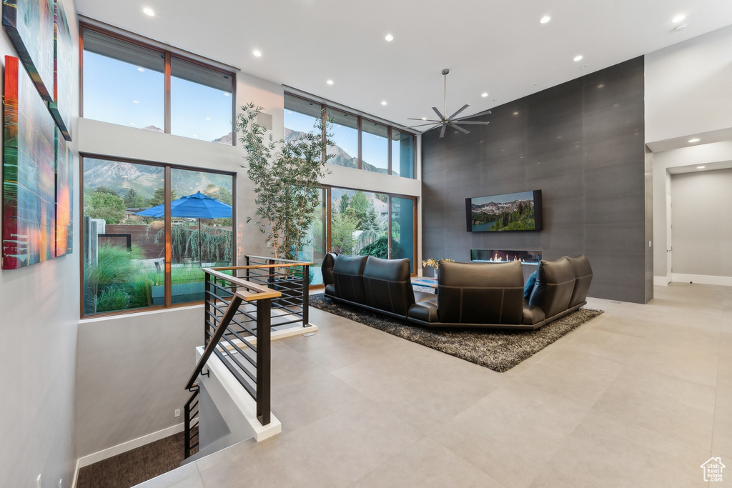 Interior space featuring ceiling fan and a towering ceiling