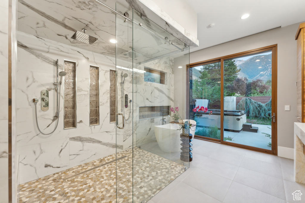 Bathroom featuring tile patterned flooring and independent shower and bath