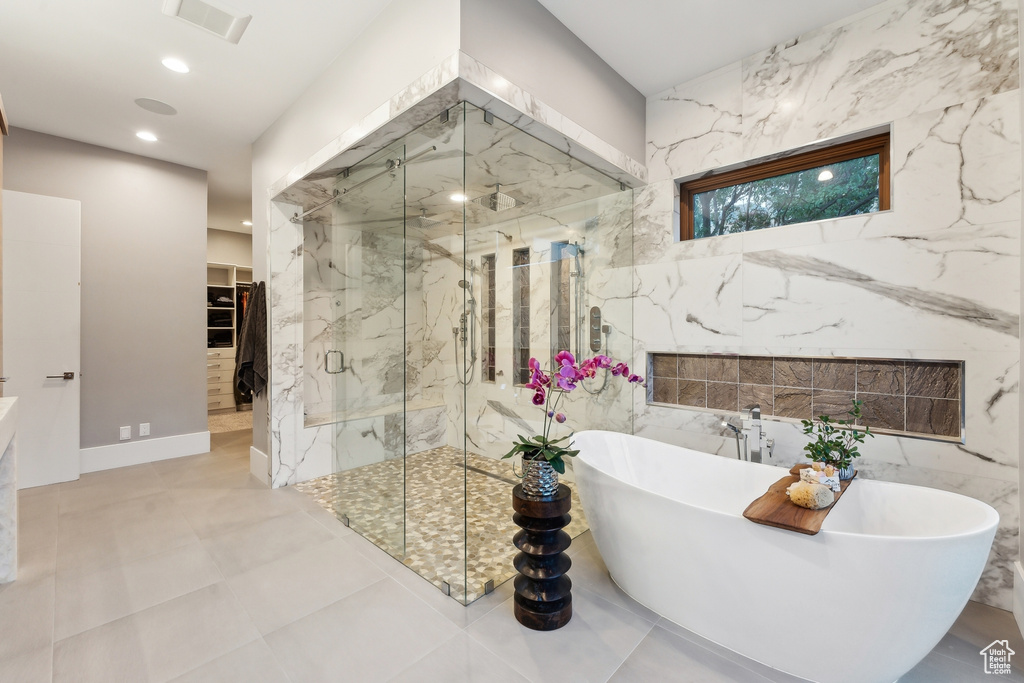 Bathroom with tile walls, plus walk in shower, and tile patterned floors