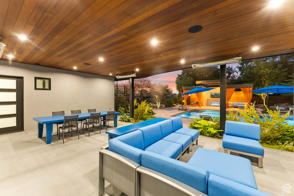 Patio terrace at dusk featuring an outdoor hangout area