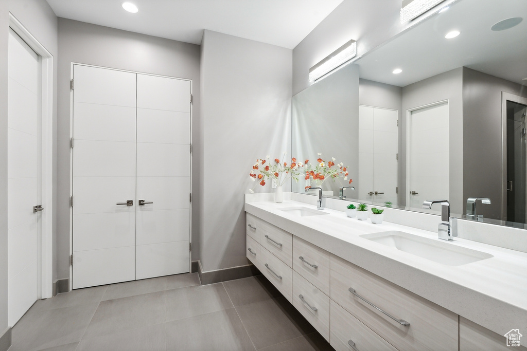 Bathroom with tile patterned floors and dual bowl vanity