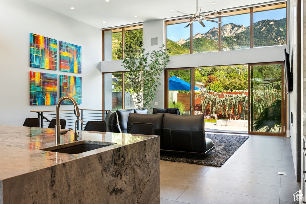 Living room with sink, a mountain view, and light tile patterned flooring