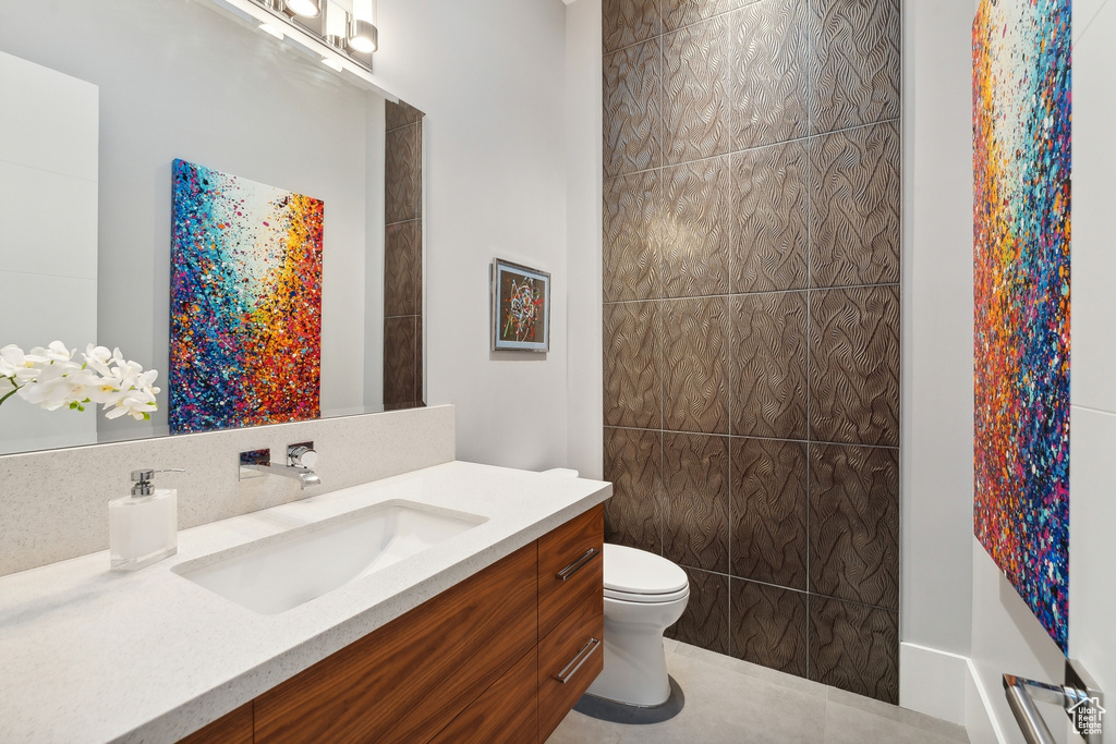 Bathroom featuring tile patterned floors, toilet, and vanity