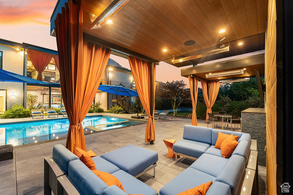 Patio terrace at dusk with outdoor lounge area