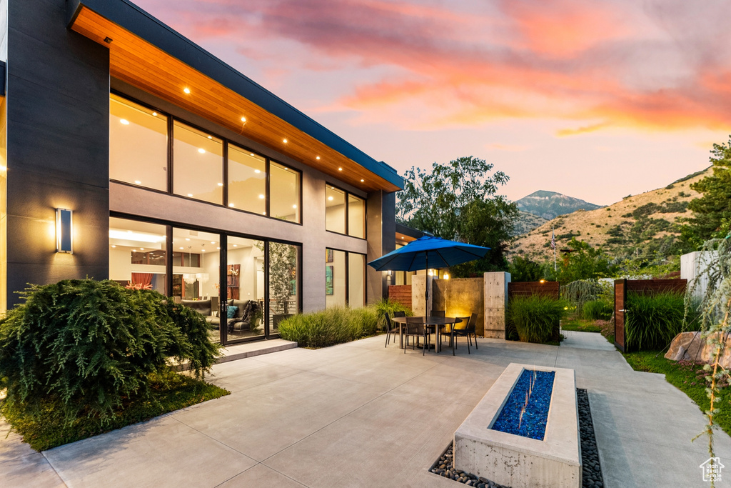 Patio terrace at dusk with a mountain view