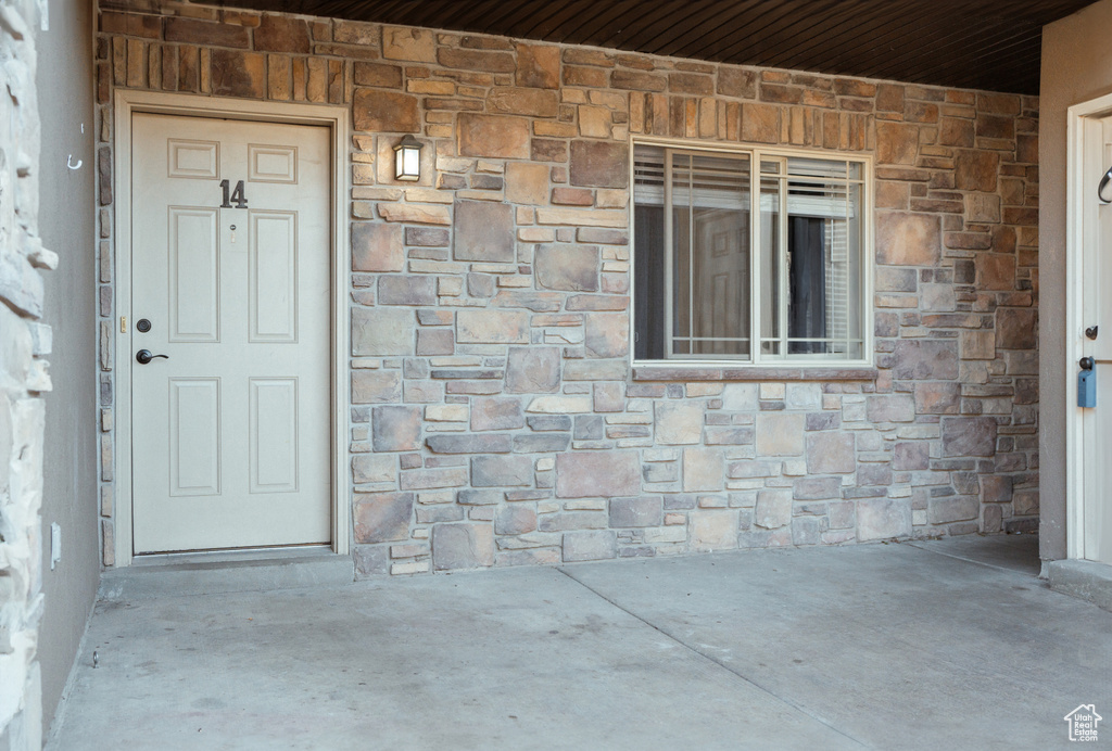 Doorway to property featuring a patio