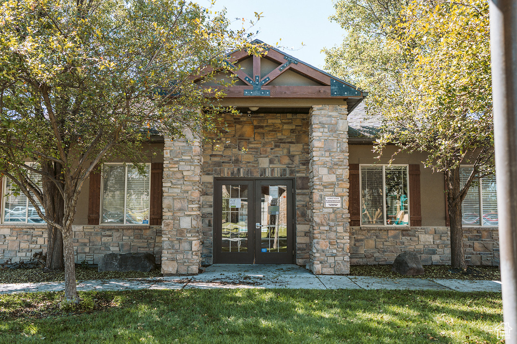 View of front of house featuring french doors and a front yard