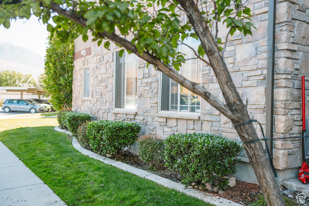 View of side of home featuring a lawn